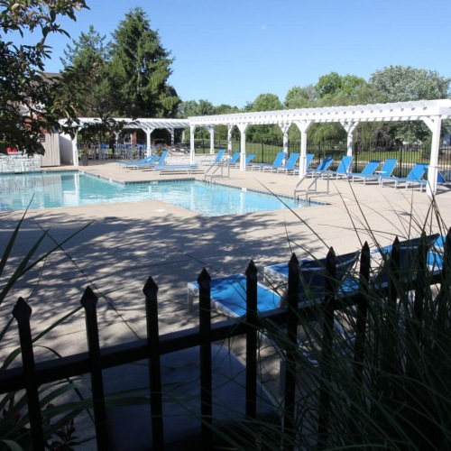 Shimmering resort-style pool a swimming pool with a fence around it