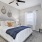 a bedroom with a bed and a fan