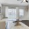 a living room with a white couch and a fan